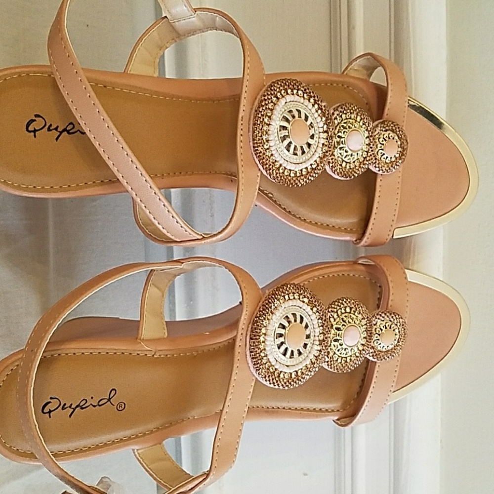 A peached coloured wedge sandals